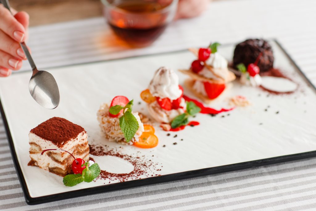 Tasting,One,Cake,From,Lots,,Close-up.,Plate,With,Five,Different